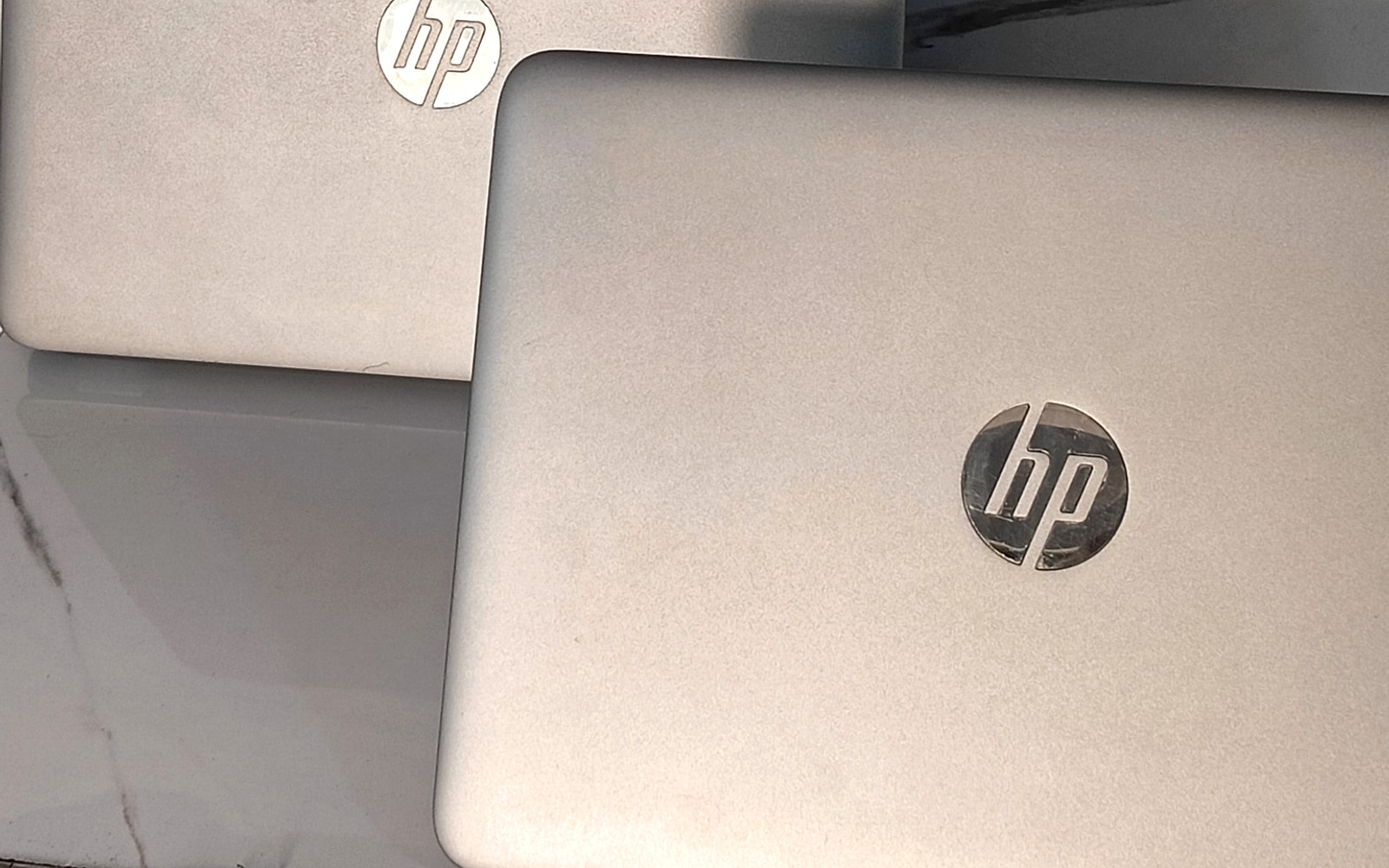 Authentic photo of customer laptops undergoing hardware inspection and diagnosis on the service desk at Perfect Solution
