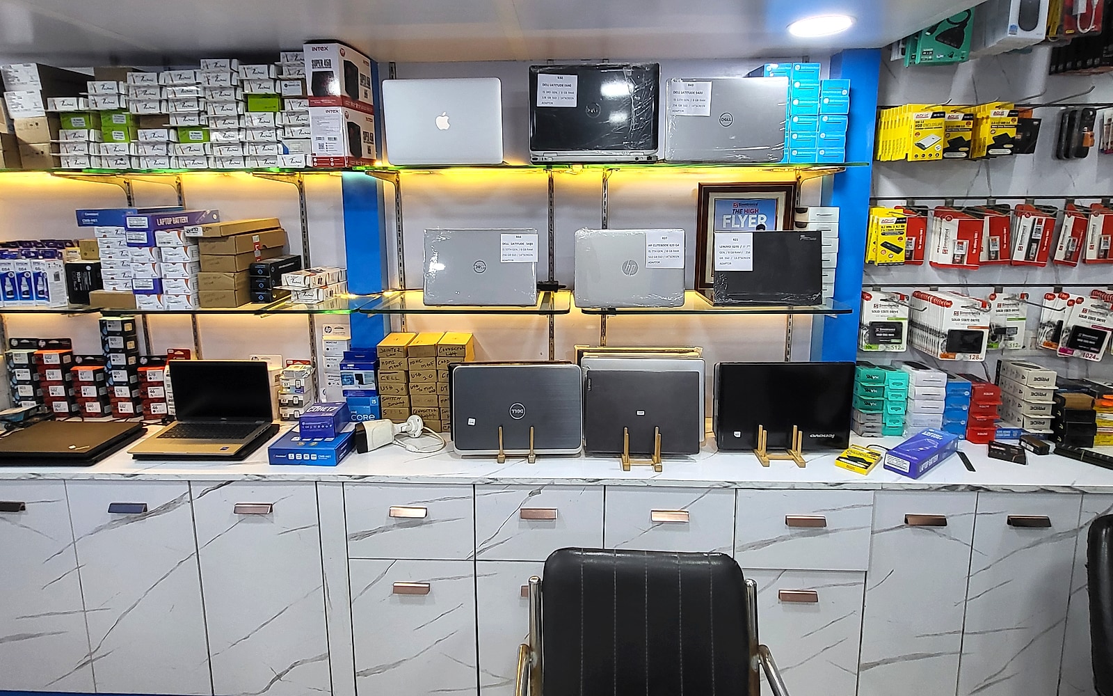 Authentic photo of Perfect Solution shop interior showing laptop display shelves and reception desk at Sky Plaza